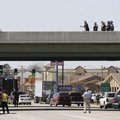 David Eugene Ruckoldt, 31, sits on the overpass of Interstate 540 and Walnut Street in Rogers on Mon...