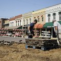 Manuel Cruz, left, and Miguel Almarez stack bricks pulled up from the intersection of First and Waln...