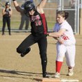 Springdale High’s Jennifer Howard reaches first base before Farmington’s Kendra Center applies the t...