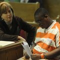 Deputy public defender Julie Tolleson, left, and Jesus Santiago consult Monday before he pleaded gui...