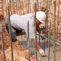 Mario Borciaga smooths fresh concrete Tuesday in a footing at the Ernie Lawrence Ice Skating/Splash ...