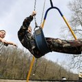 Jovanny Olson, 4, left, gives new friend Peter Barnard, 5, a push on a swing set Tuesday at Lake Ata...
