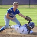 Rogers High shortstop Ashley Ferguson, left, reaches to apply the late tag as Fayetteville’s Maddy M...