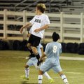 Bentonville junior Nathan Bracy, top, heads the ball over Springdale Har-Ber’s Maricio Salas in the ...