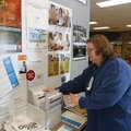  Janet Moore of Rogers sorts through census forms  at the Rogers Activity Center while waiting to as...