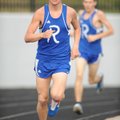 Rogers High’s Jeremiah Fleeman rounds the final curve before placing second in the 1,600-meter run d...