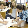 Students in Yvonne Durfee’s advanced English class, from left, Casi Caton and Rebecca Daniel work on...