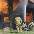 Josh Chapman with the Rogers Fire Department, left, supervises rookie firefighters during a training...