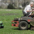 Carson Thomas, 4, left, follows his great-grandfather, Ed Coombs of Springdale, as he mows the lawn ...