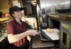 EXPANDED MENU - “Sandwich artist” Ashley Zimmerman prepares a breakfast sandwich Wednesday at Subway at Village on the Creeks in Rogers. The sandwich giant will officially begin serving breakfast in its stores nationwide beginning Monday and will also offer Seattle’s Best coffee. The Rogers location has been serving breakfast since March 29 as a way to introduce the new menu item to customers.
