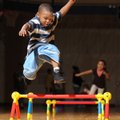 LEAPING LAVAN - Lavan Douglas, 6, leaps over a hurdle Friday ahead of Mekiah Goodhart, 8, while part...