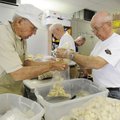 Richard Harris, right, and Charles Cotton package breaded chicken pieces donated by Tyson Foods.