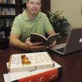 Pastor Mike McDaniel uses books for research before writing his Easter sermon in his office at Grace...