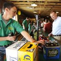 MACADOODLES OPENING - Chris Thomas, right, buys beer Friday from Mike James at the grand opening of ...