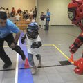  Deputy Scott Santos, left, helps guide Nevaeh Wahlberg, 6, of Bentonville, to run away from an atta...
