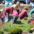 Children scramble for hundreds of eggs Saturday during Easter Eggstravaganza on the Bentonville Squ...
