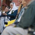  Helen Hager of Rogers (left) and a small gathering pray during an Easter sunrise service at the Fri...