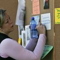  Rachel McCome of Fayetteville posts a note on the memorial wall Saturday morning at the Surviving t...
