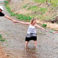 Mike Hinesley, from left, Jenn Terry and her nephew Max Terry, 7, stretch to retrieve a discarded ba...