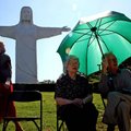 Lola Weems (middle) and her husband McKinley Weems (right) both of Eureka Springs enjoy the shade of...
