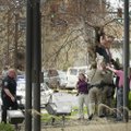Police pull Abel Tomlinson of Fayetteville from a tree in front of the Washington County Courthouse ...