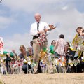 Police Chief Steve Hamilton helps place 466 pinwheels in front of the Rogers Police Station on Monda...