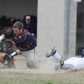 Springdale Har-Ber’s Preston Pianalto safely slides into home as Rogers Heritage’s Spanky Purdy bobb...