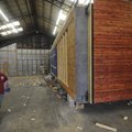University of Arkansas architecture students prepare a piece of a modular home Tuesday for transport...
