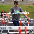 Rogers Heritage High School senior Michael Burner removes hurdles Tuesday from the track at Gates St...