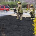 Springdale firefighters douse a grass fire Tuesday at 2359 Cimmaron Avenue in Springdale. Strong win...