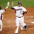 Arkansas' Zack Cox is greeted by Bo Bigham as he scores a run last month in the bottom of the first ...