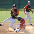Gravette second baseman Chris Cowgur, left, misplays the throw from the plate as Farmington’s Alex M...