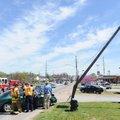 DIRECT HIT - Fayetteville police and fire personnel attend to a Ford Taurus after the vehicle’s driv...