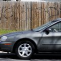 A car passes by a fence covered in graffiti April 1 on West End Street in Springdale.