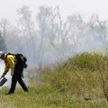  Joe Bennett of Guthrie, Okla., starts a controlled burn Friday at the north side of Lake Fayettevil...