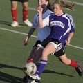 Fayetteville sophomore Lindsay Borderlon, right, kicks for a goal as Springdale High’s Brittany Jerg...