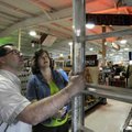  Kevin Williams, manager of Meeks Lumber and Hardware, helps Anna Boyd of Bentonville pick out a lad...