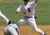 Bentonville’s Logan Pearson waits for the throw from catcher Blake Baxendale while attempting to pick off Bishop Kelley’s Alex Johnson at second base during the Tigers’ game Saturday against the Comets at the Tiger Athletic Complex in Bentonville.