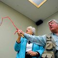  John Blair, right, shows Elaine Rooney of Bella Vista the proper fly casting technique Saturday dur...