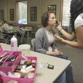 Sindy Vega, right, applies makeup to Ashley Tibbitts, 18, of Rogers, before Tibbitts has her portrai...