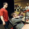  Blake Talbot, center, of Little Rock watches a computer monitor as consultants Dustin Kinsel, left,...