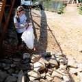 Sara Yingling, Fayetteville high school senior, 
collects trash Saturday from under a pedestrian br...