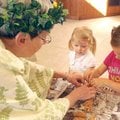  Judy Pertle, from left, as Mother Nature helps Lilian Hanlon, 4, and her sister Vivian Hanlon sort ...