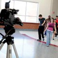  Springdale High School senior Irvin Camacho, left, watches Saturday as a group of students dance wh...