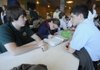Carter Lankford, 15, left, and Jesse Colwell, 14, right, visit Thursday while Kayla Close, 16, center, works on calculus at Haas Hall Academy in Fayetteville.