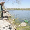 Carlos Garcia of Springdale fishes Sunday off the dam at Lake Fayetteville. Garcia said he had caugh...