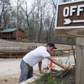 Joshua Elders builds a retaining wall Monday at the entrance of Camp War Eagle. The camp is working ...