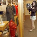  
Marianela Alicea, 18, of Springdale takes photos of the pieces in "Answering the Call," an exhibi...