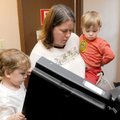 Jack Burns, 4, left, and brother Oliver Burns, 2, watch their mother, Jodie Burns, vote in the Bento...