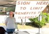 Jan Lea from Secure Arkansas seeks signers Tuesday to a petition to limit benefits to illegal immigrants. Lea set up her petition booth at the Bentonville Church of Christ, a polling place for the school district millage election.